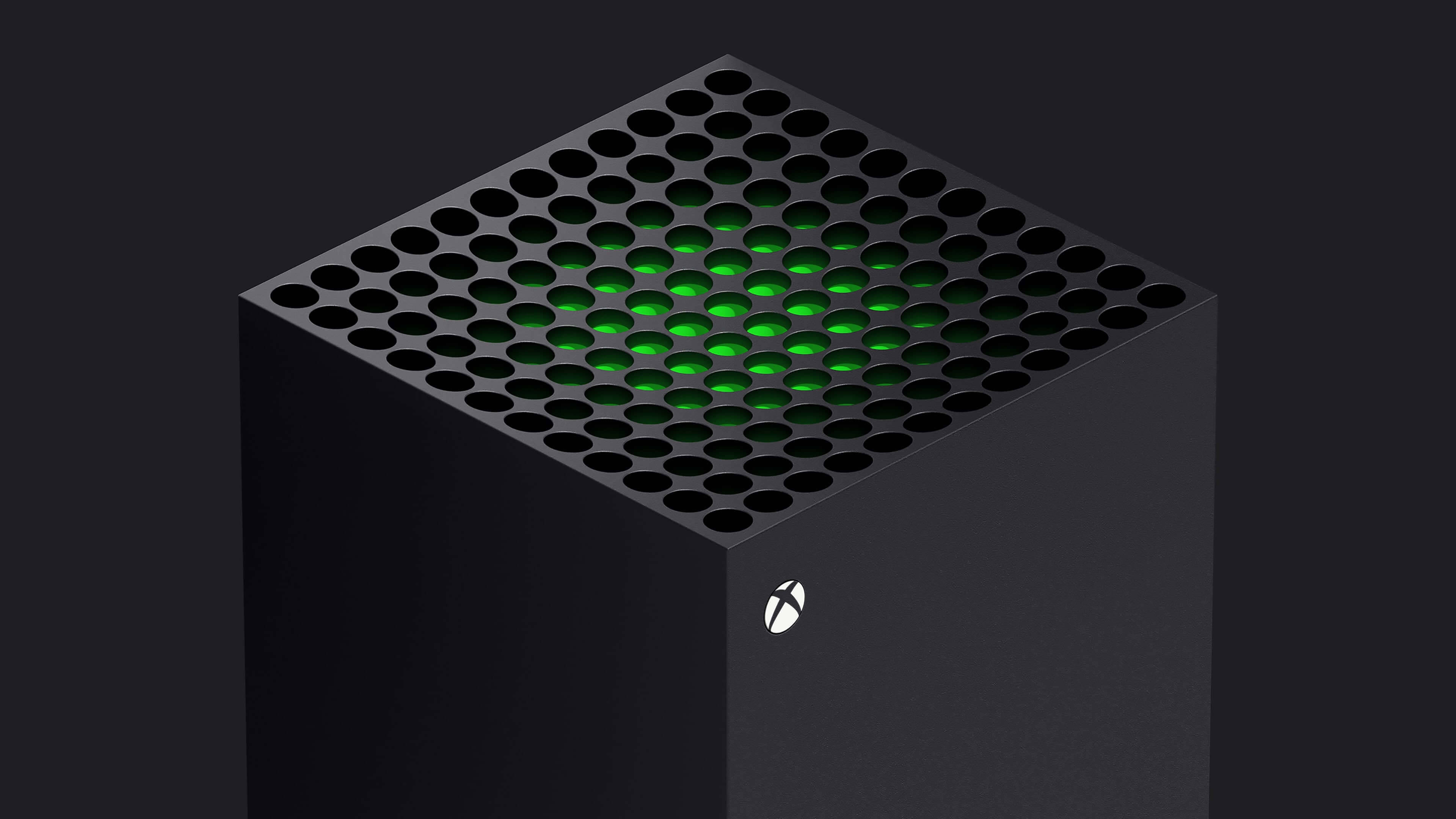 Microsoft Xbox Series X 壁紙 — 一部時尚的黑色 Xbox Series X 主機，透過穿孔頂板發出綠色 LED 光芒，背景為深色。