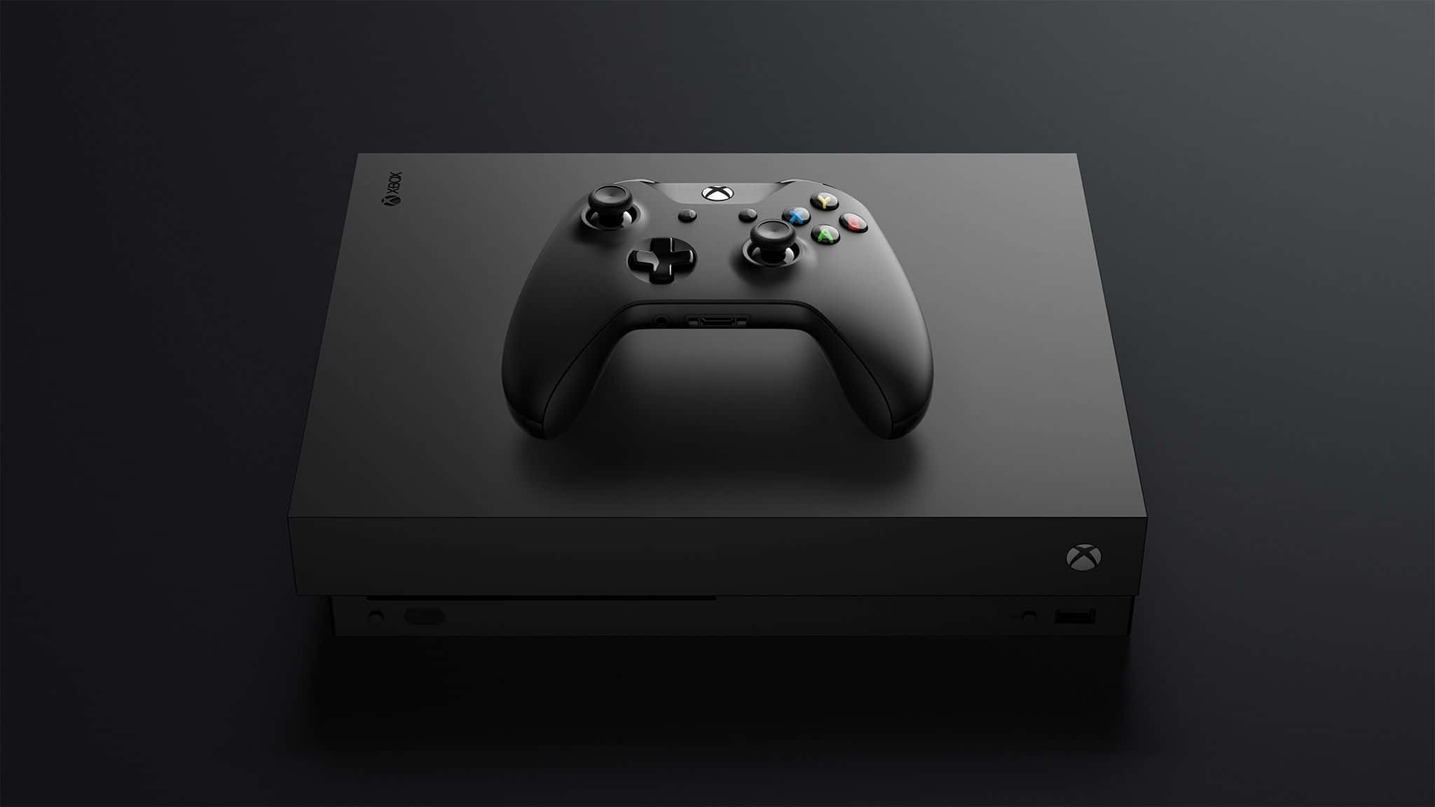Gaming Consoles 桌布 壁紙 — 一部時尚的黑色 Xbox 主機及相配的控制器，在柔和的工作室燈光下放置於深色漸變表面上。