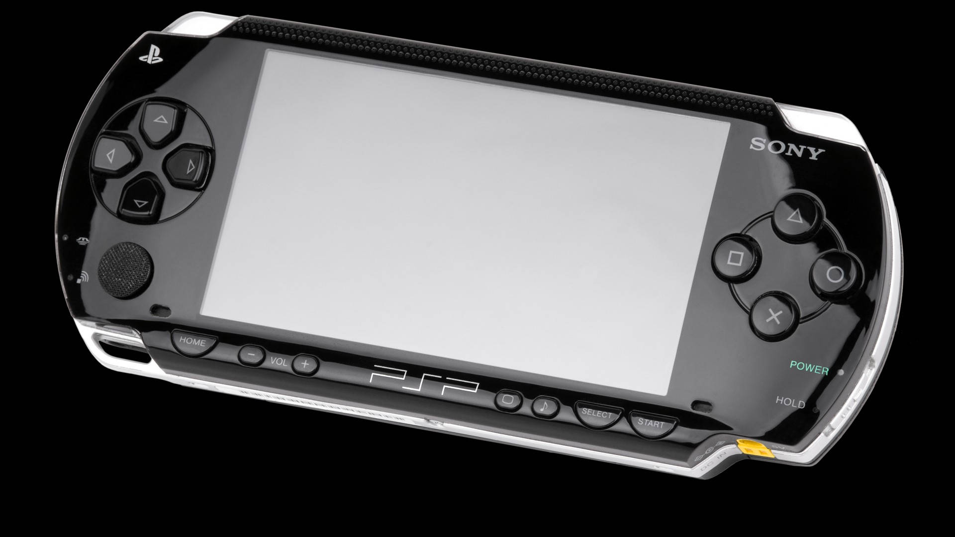 黑色和銀色 Sony PSP 遊戲機，配備空白屏幕和發光的電源按鈕。 — PlayStation GIF 壁紙