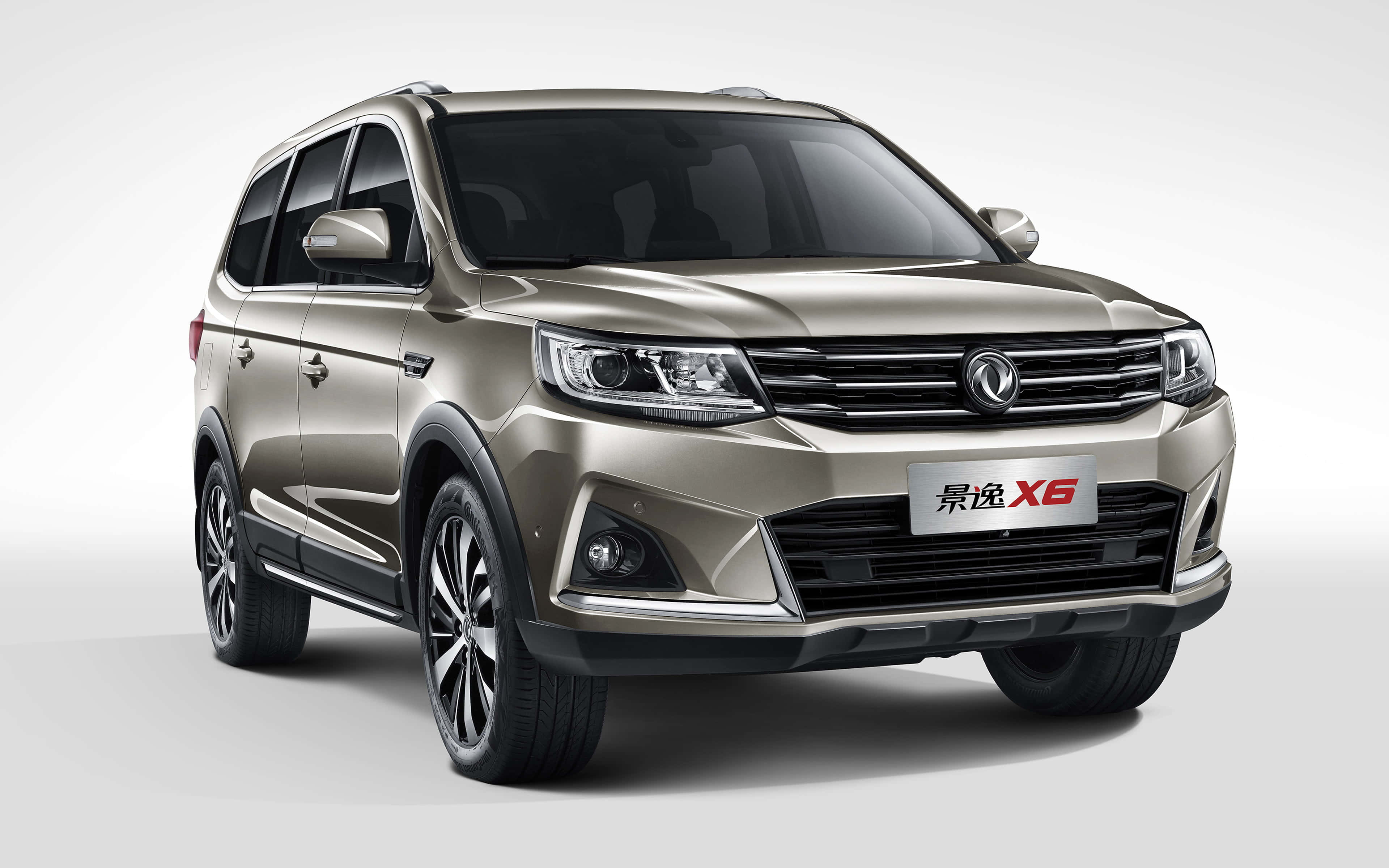 Dongfeng 桌布 壁紙 — 一部時尚金色SUV，配備現代頭燈和鍍鉻飾邊，在潔白的工作室背景前展現姿態。