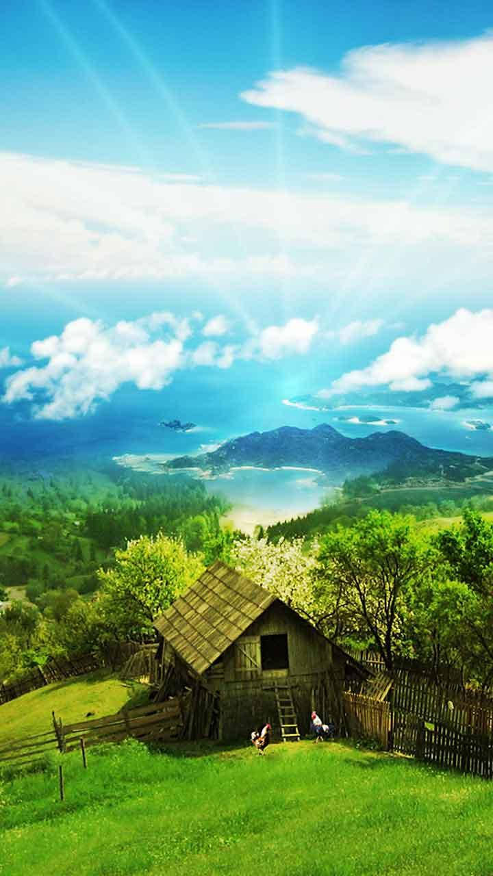 雲 桌布 壁紙 — 一間質樸的木屋坐落在充滿活力的綠色山丘上，上方是明亮的藍天，陽光普照，遠山連綿。