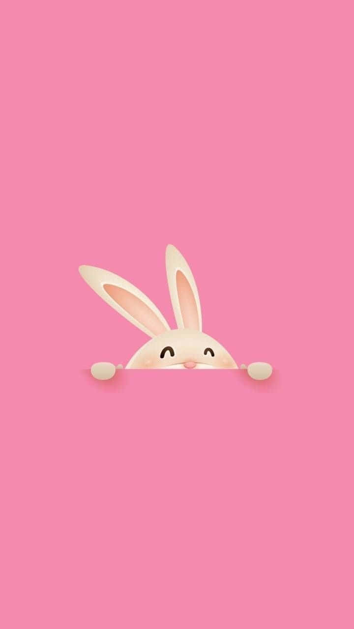 Pink Bunny 桌布 壁紙 — 一隻可愛嘅卡通兔仔喺粉紅色表面上面露出頭嚟，帶住開心嘅笑容同細細嘅爪。