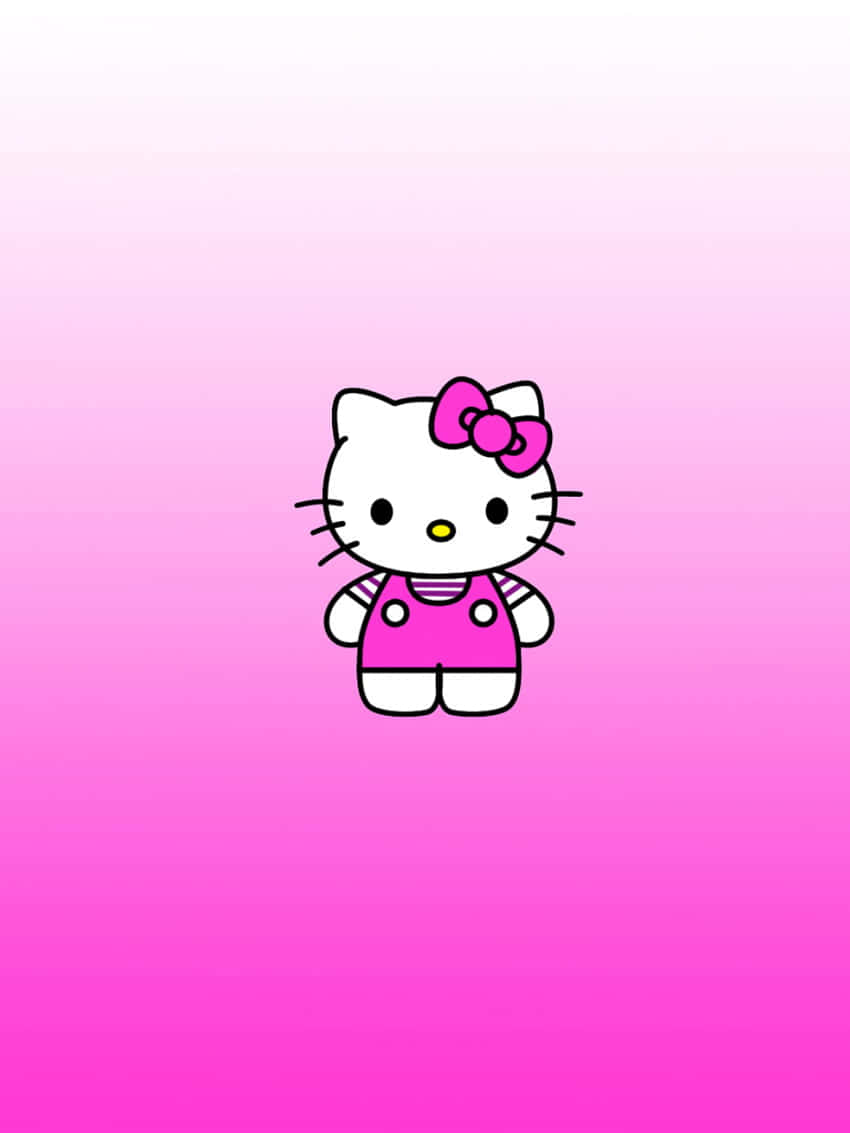 Kawaii Hello Kitty 桌布 壁紙 — 一隻可愛的卡通貓咪，戴著粉紅色蝴蝶結和穿著吊帶褲，站在柔和的粉紅色漸變背景中央。
