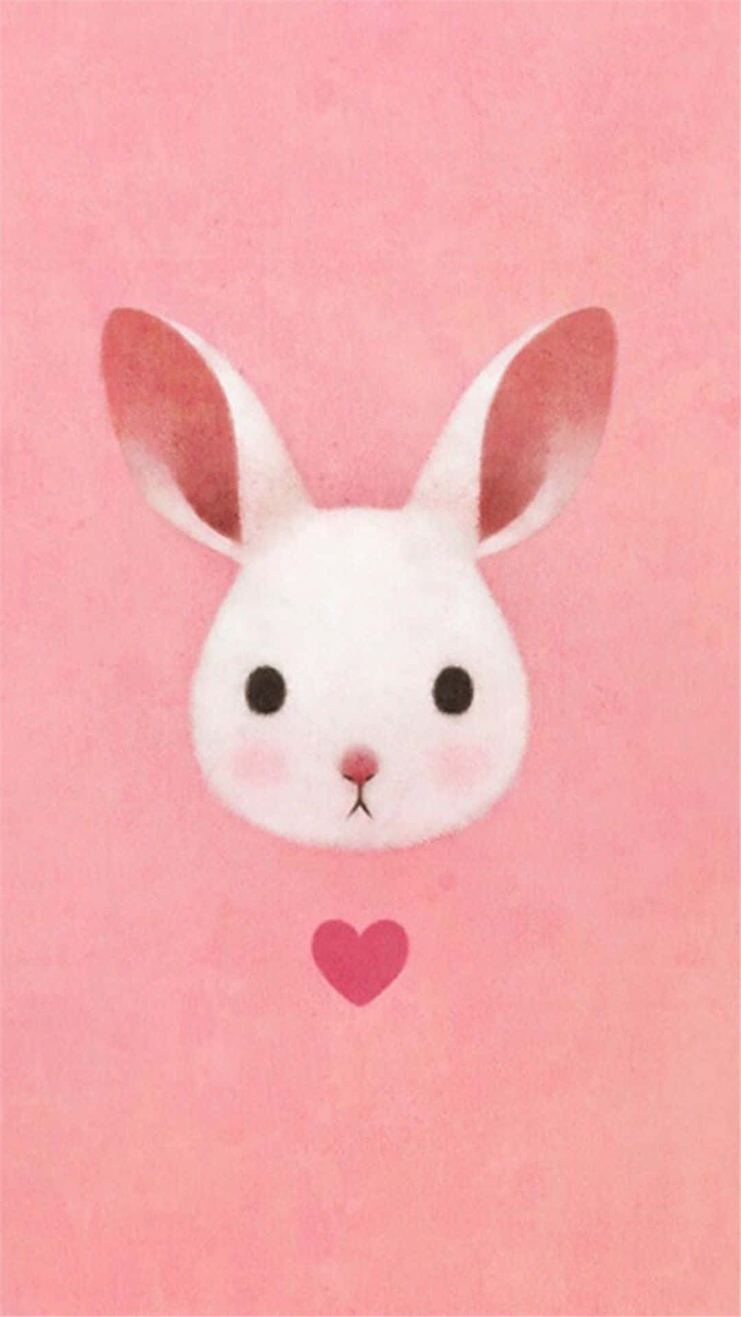 Pink Bunny 桌布 壁紙 — 一隻可愛的白色兔子，有粉紅色的內耳，下方有一個小心形，襯以柔和的粉紅色水彩背景。