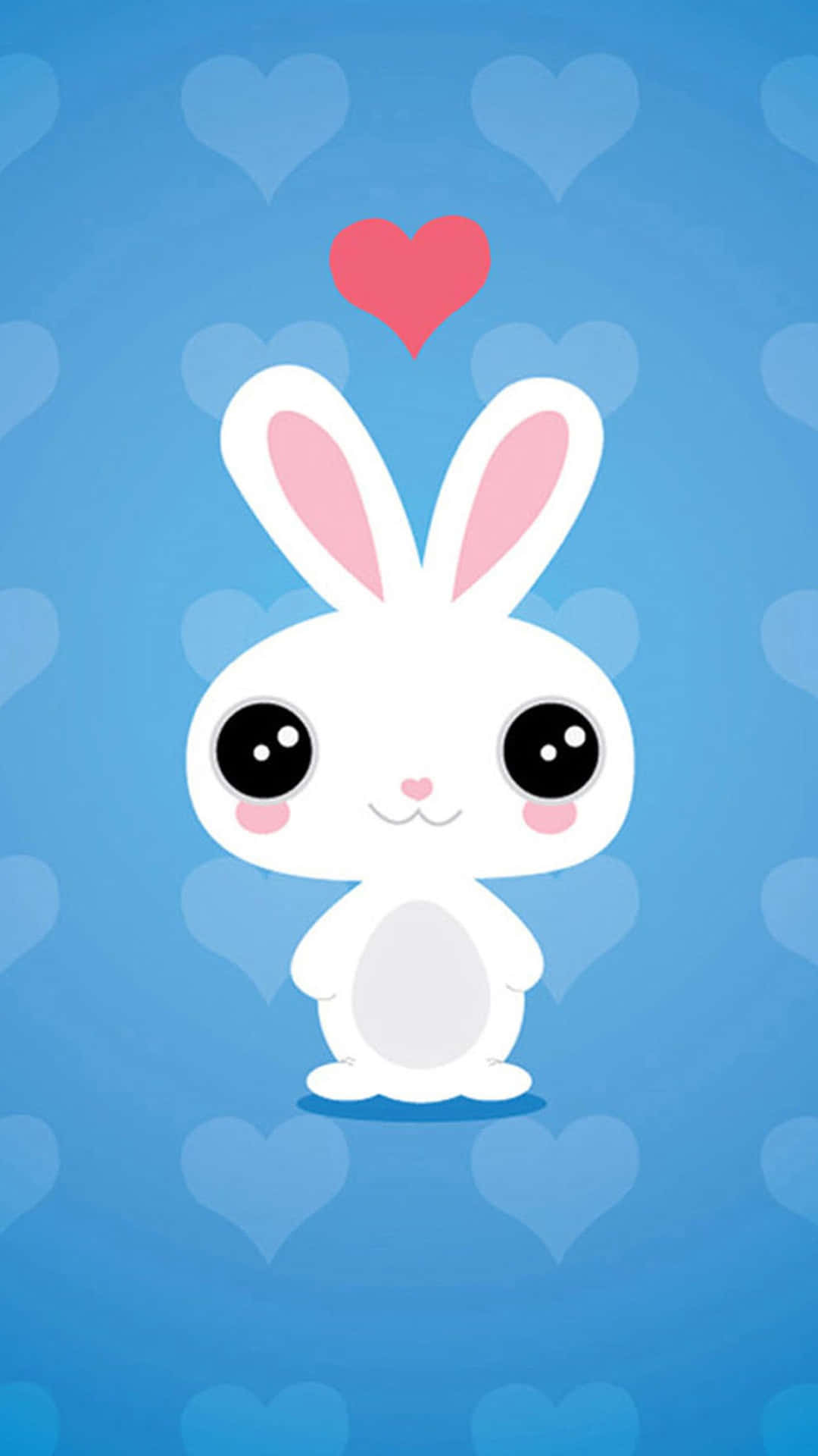 Kawaii Bunny 桌布 壁紙 — 一隻可愛的白色卡通兔，有粉紅色的內耳和臉頰，站在點綴著心形的藍色背景前，頭頂上漂浮著一顆紅心。