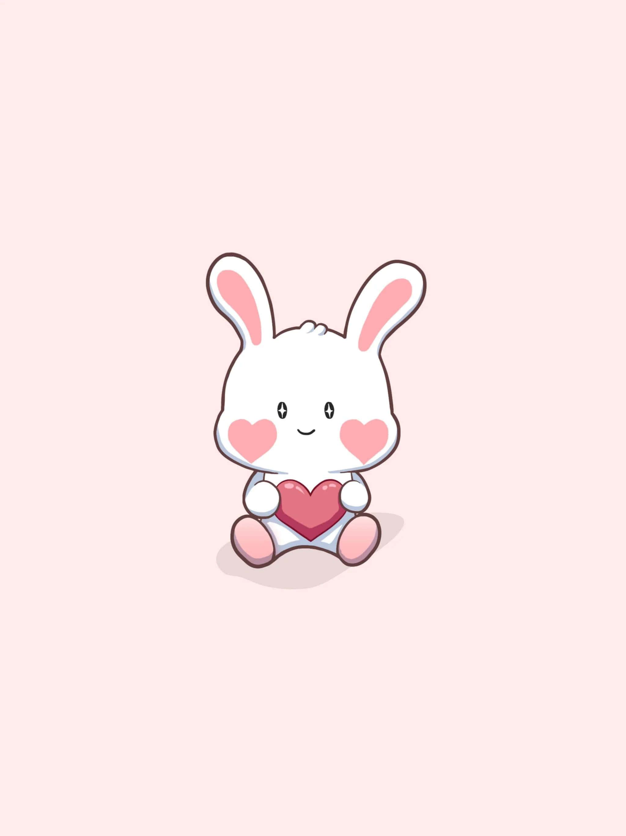 Cartoon Heart 桌布 壁紙 — 一隻可愛的白色卡通兔仔，有粉紅色面頰和耳朵，在柔和的粉紅色背景上拿著一個紅色心形。