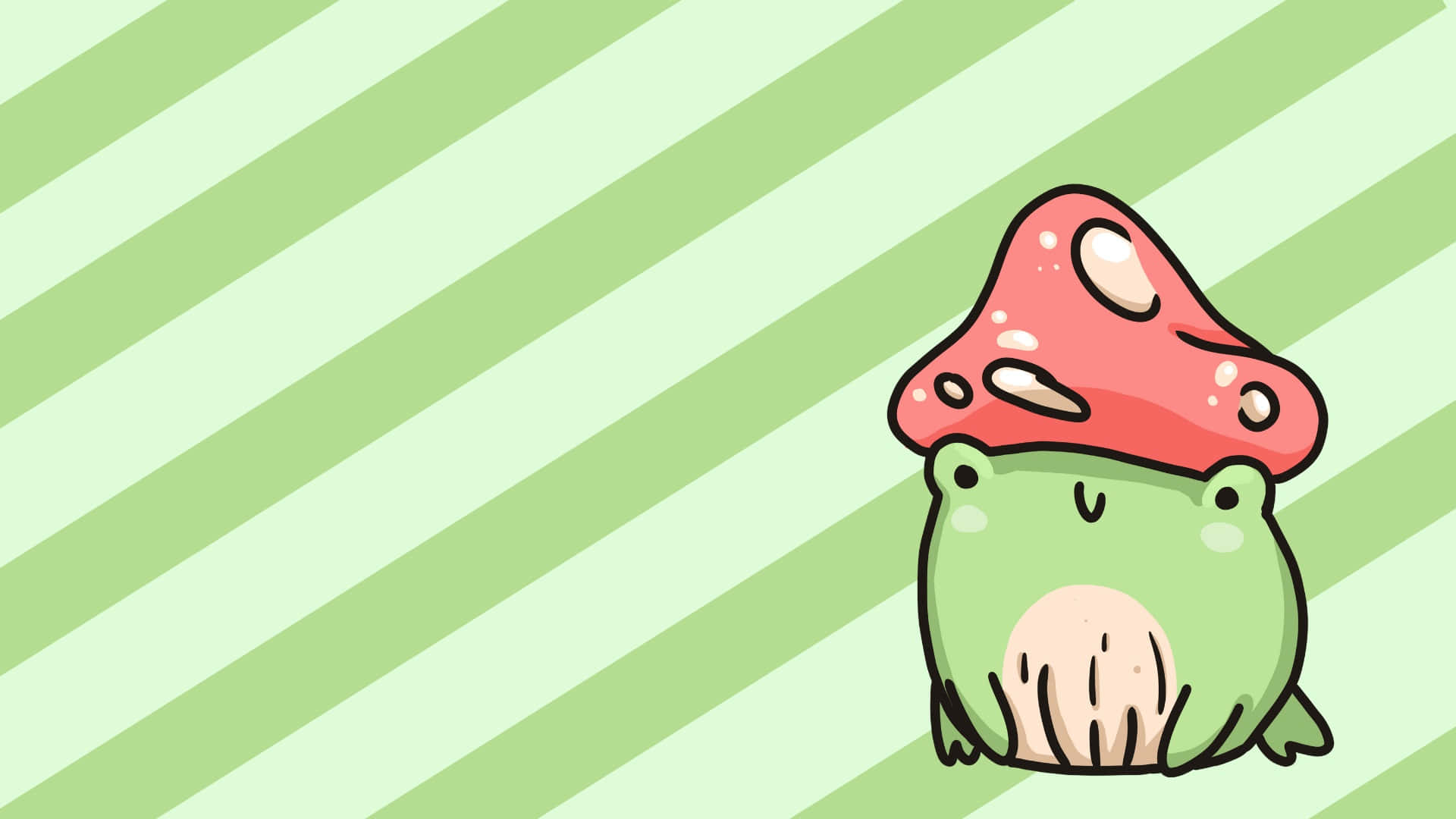 Cute Frog 桌布 壁紙 — 一隻可愛的綠色青蛙戴著紅色蘑菇帽，坐在淺綠色斜紋背景前。