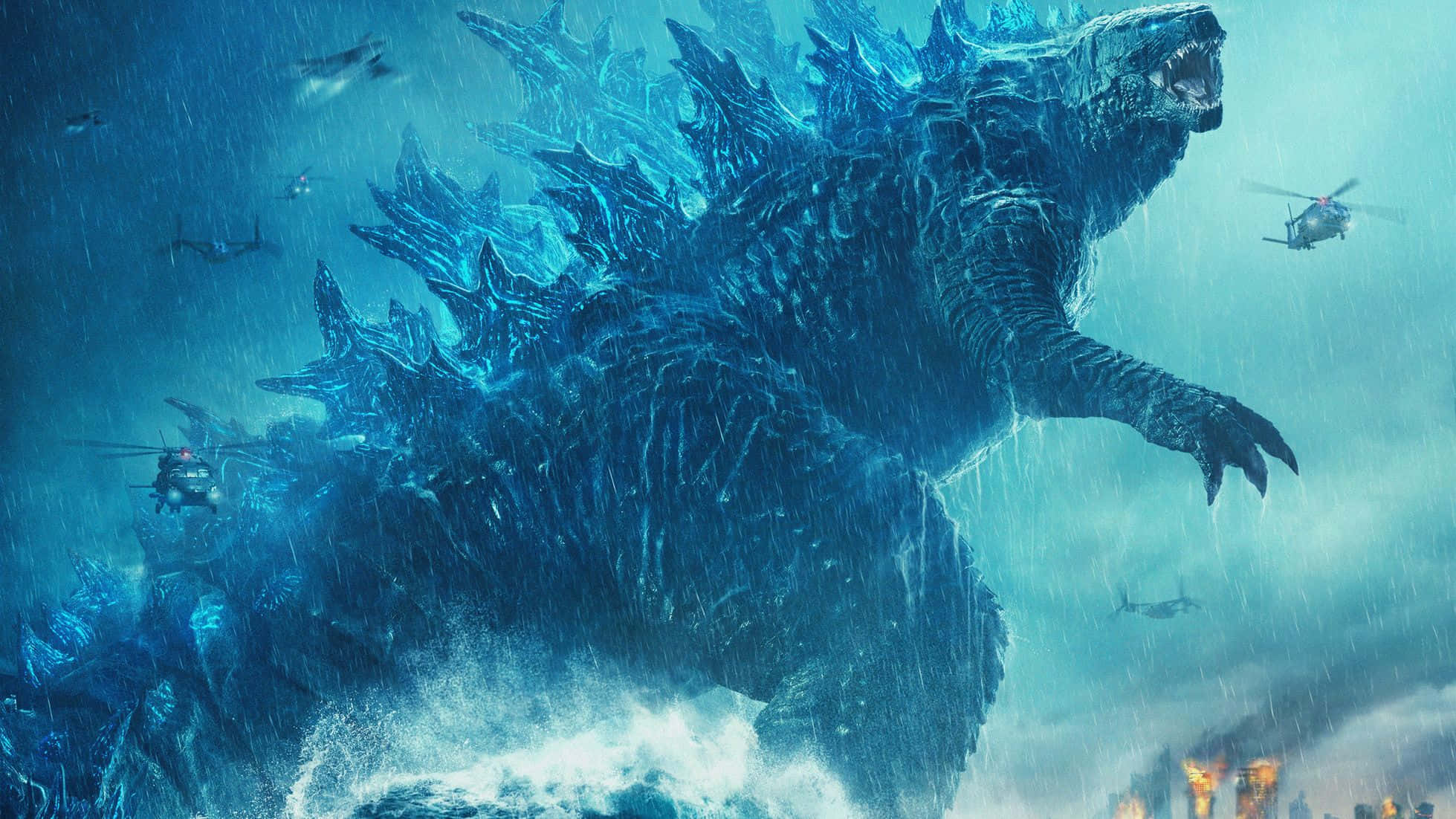 Godzilla Art 桌布 壁紙 — 一隻巨大的藍色哥斯拉從暴風雨的海浪中出現，直升機在雨中於燃燒的城市上空戰鬥。