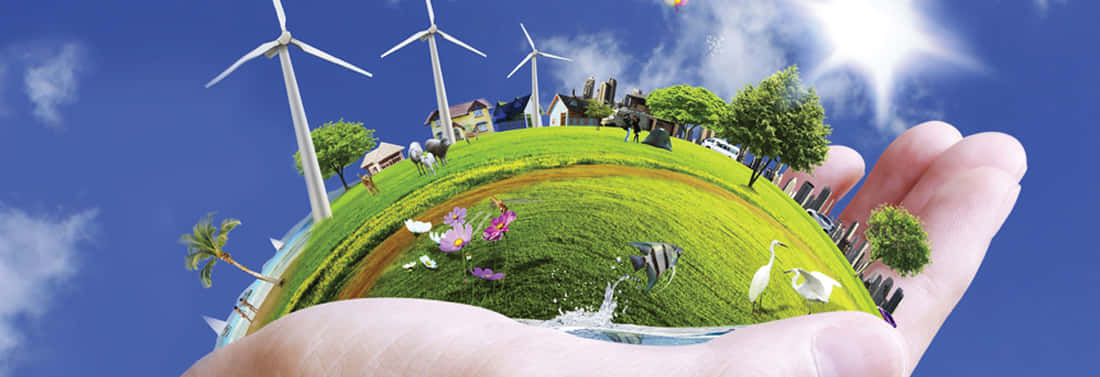 Green Technology 桌布 壁紙 — 一隻手托住一個微型地球儀，上面顯示風力渦輪機、房屋、樹木和野生動物，背景是明亮的藍天。