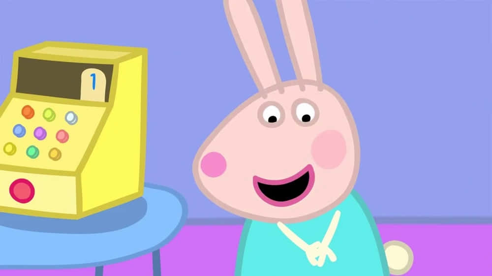 Rebecca Rabbit 桌布 壁紙 — 一隻穿著青綠色襯衫的開心卡通兔仔，喺藍色枱上一個黃色玩具收銀機旁邊微笑。