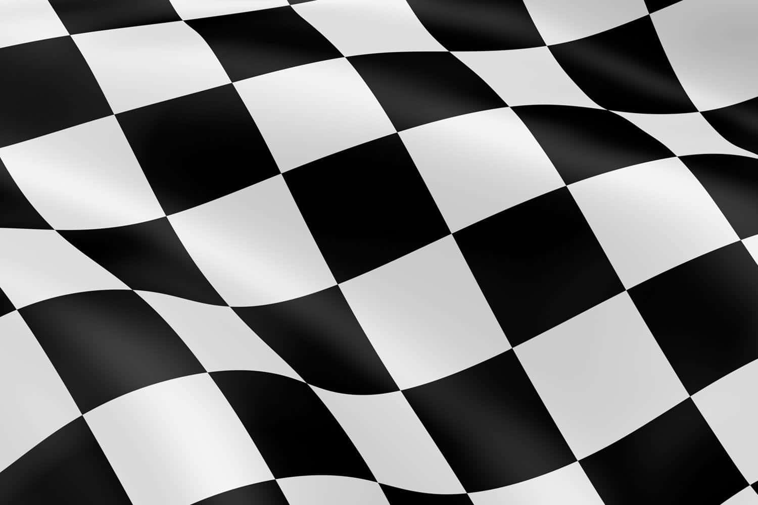 Checkered Flag 桌布 壁紙 — 一面充滿動感的黑白格仔賽車旗在明亮光線下飄揚，帶有清晰的摺痕。