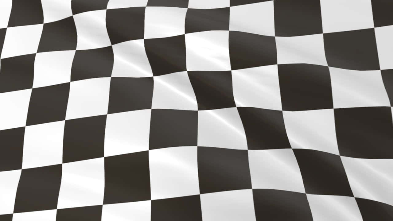 Chequered Flag 桌布 壁紙 — 一面動感的黑白格仔賽車旗隨風飄揚，帶有清晰的摺痕和閃亮的高光。