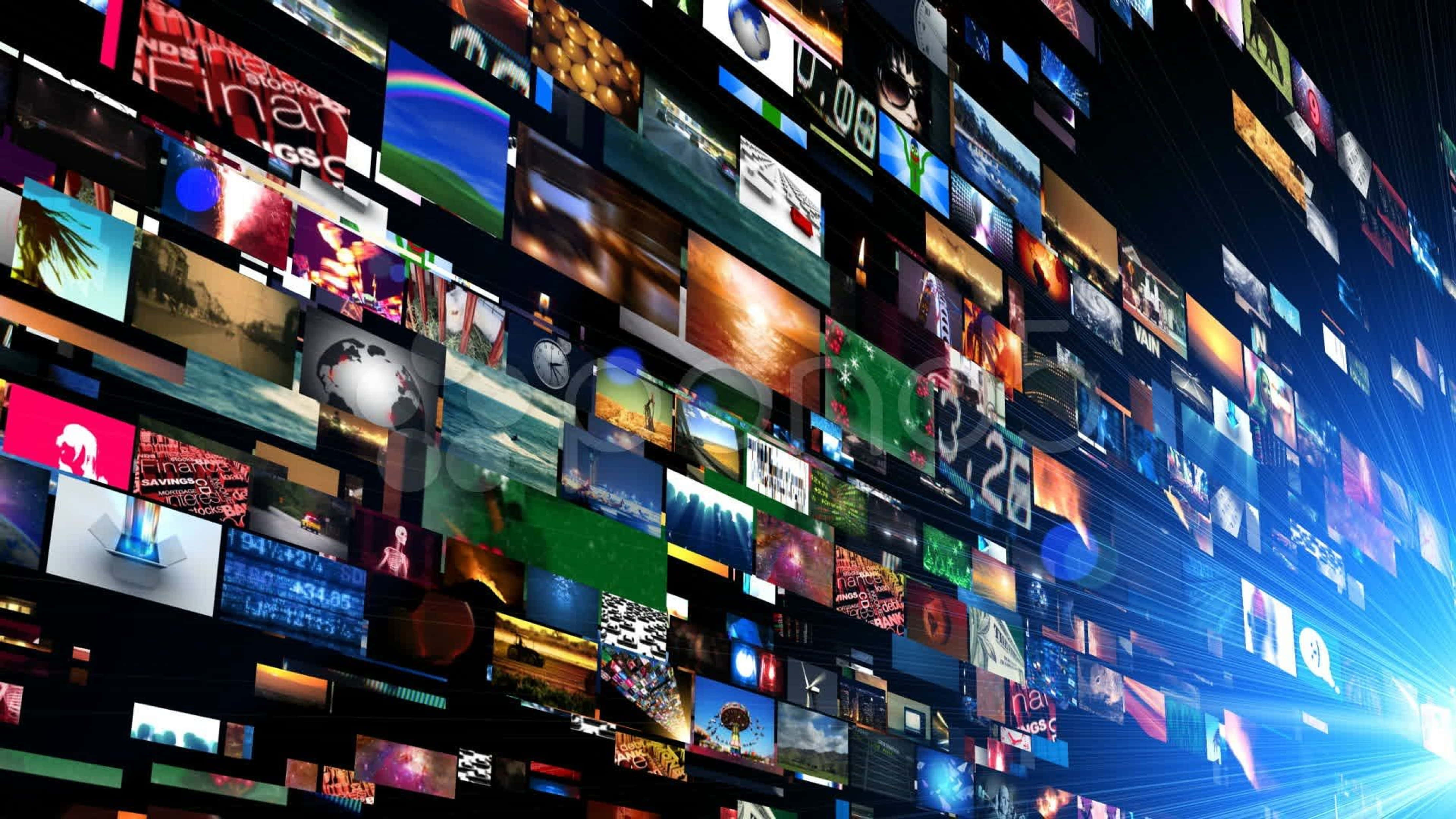 4K Streaming 桌布 壁紙 — 一面動態的數碼牆，由發光的屏幕組成，在黑暗背景中顯示多樣內容，並帶有藍色光線。