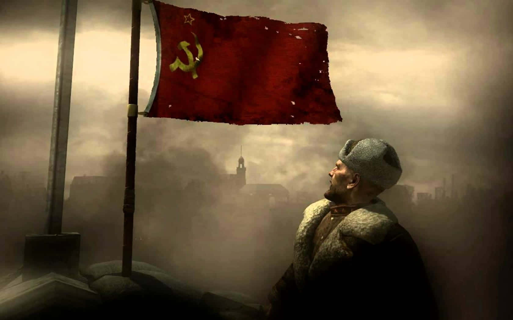 Viktor Reznov 桌布 壁紙 — 一面風化的蘇聯旗幟在陰沉、霧濛濛的城市廢墟中飄揚，一位留著鬍鬚、戴著皮帽的男子神情莊嚴地向上凝視。