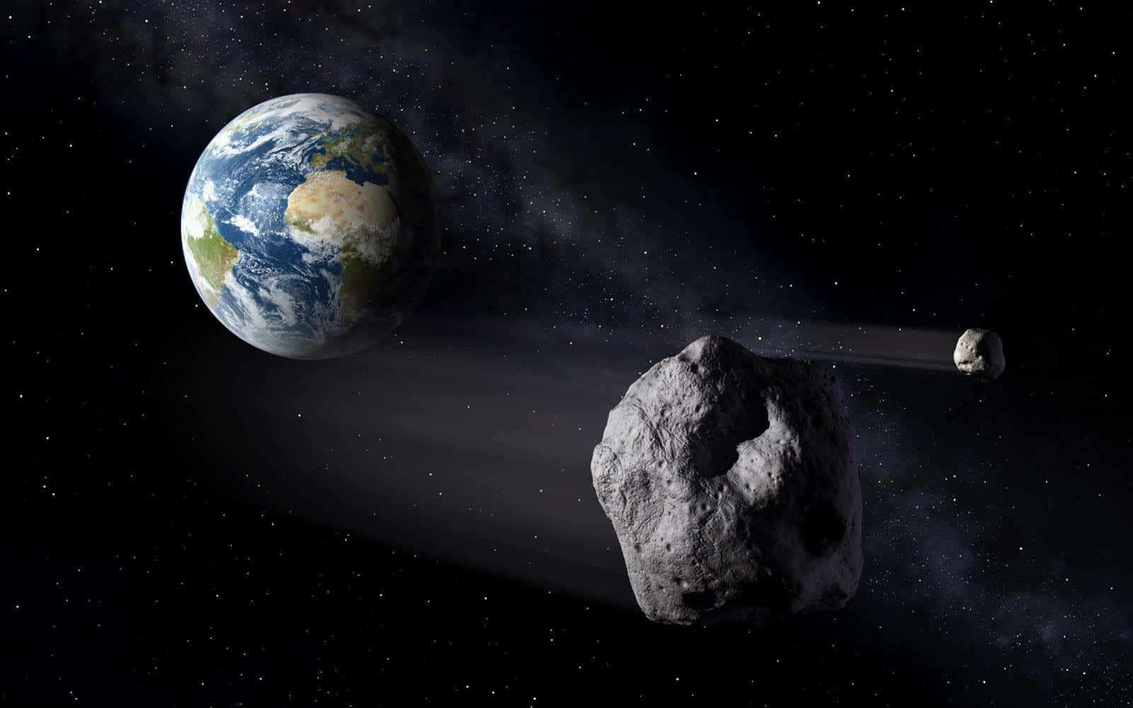 Asteroid 桌布 壁紙 — 一顆巨大的小行星掠過地球，背景是繁星點點的宇宙，後面還有一顆較小的小行星。