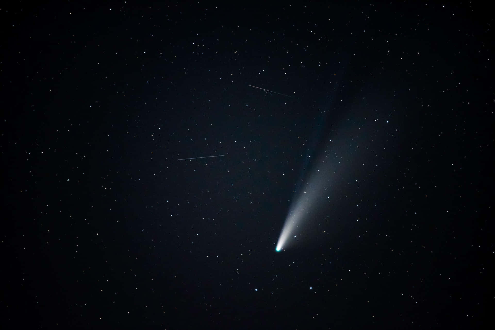 comet 桌布 壁紙 — 一顆明亮的彗星劃過繁星點點的夜空，帶有發光的尾巴和微弱的流星痕跡。