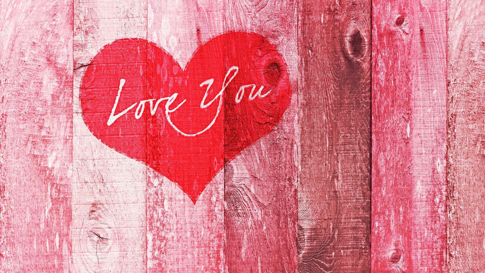 粉紅色木背景上寫有「Love You」的紅心。 — 粉紅色心形動圖 壁紙