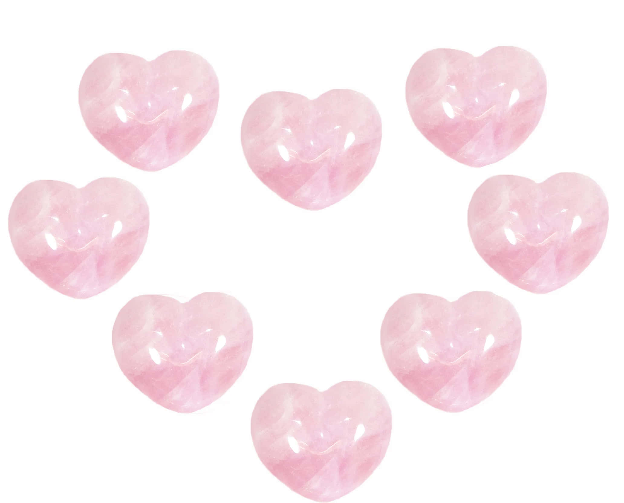 Pink Crystal Quartz 桌布 壁紙 — 七顆拋光粉紅玫瑰石英心形石，以鬆散圓形排列在純白背景上。
