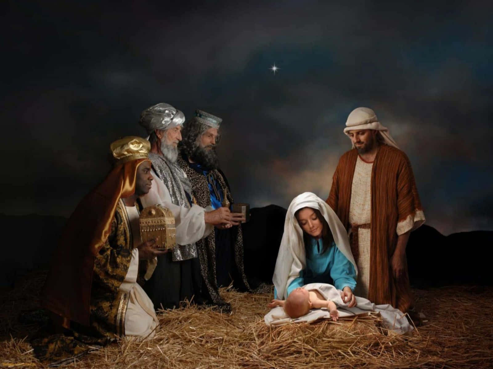Nativity Scene 桌布 壁紙 — 三位智者在繁星點點的夜空下向瑪利亞和約瑟懷中的嬰兒耶穌獻上禮物。