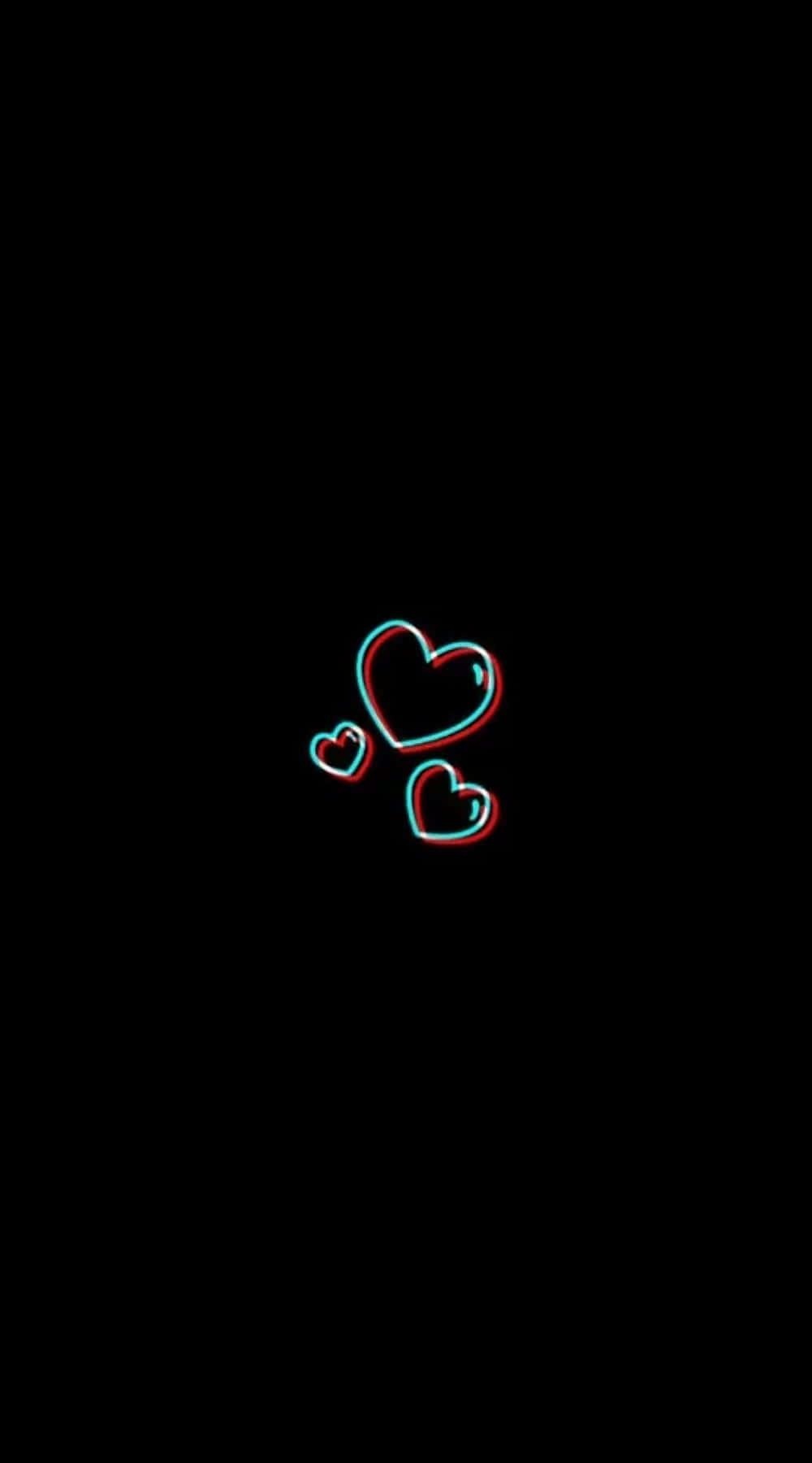 Aesthetic Black Heart 桌布 壁紙 — 三個發光的心形，帶有紅色和青色輪廓，漂浮在純黑色背景上。
