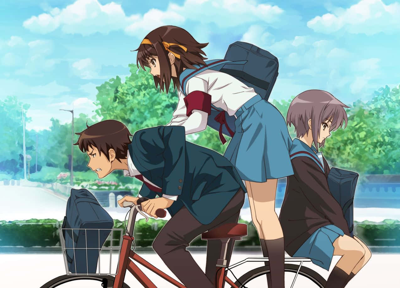Kyon 桌布 壁紙 — 三名動漫學生騎著紅色單車穿過陽光明媚的公園，公園裡有茂密的綠樹和明亮的藍天。