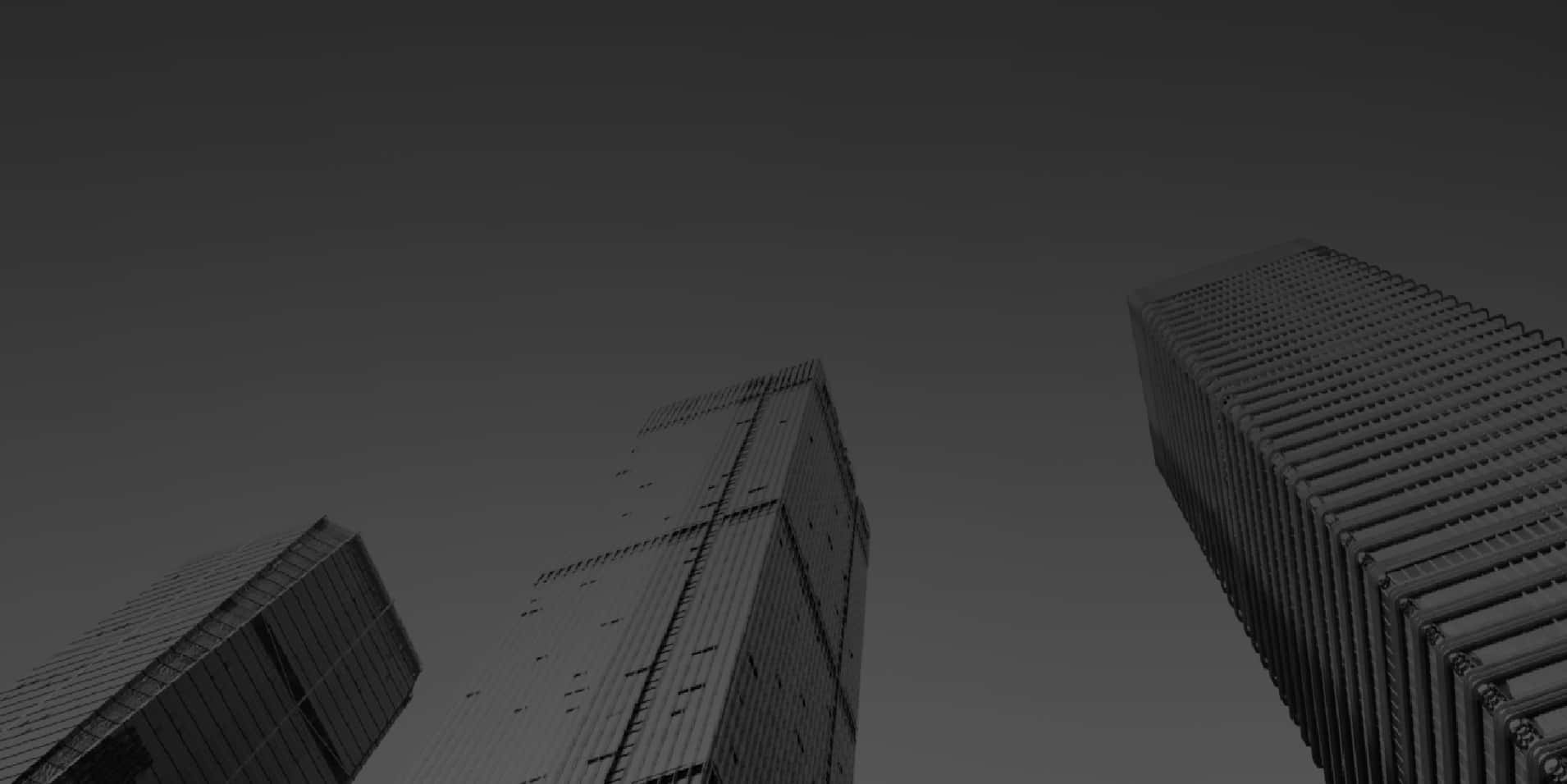 Twitter Header 桌布 壁紙 — 三座高聳摩天大樓穿透漸變灰色天空的單色低角度視圖。