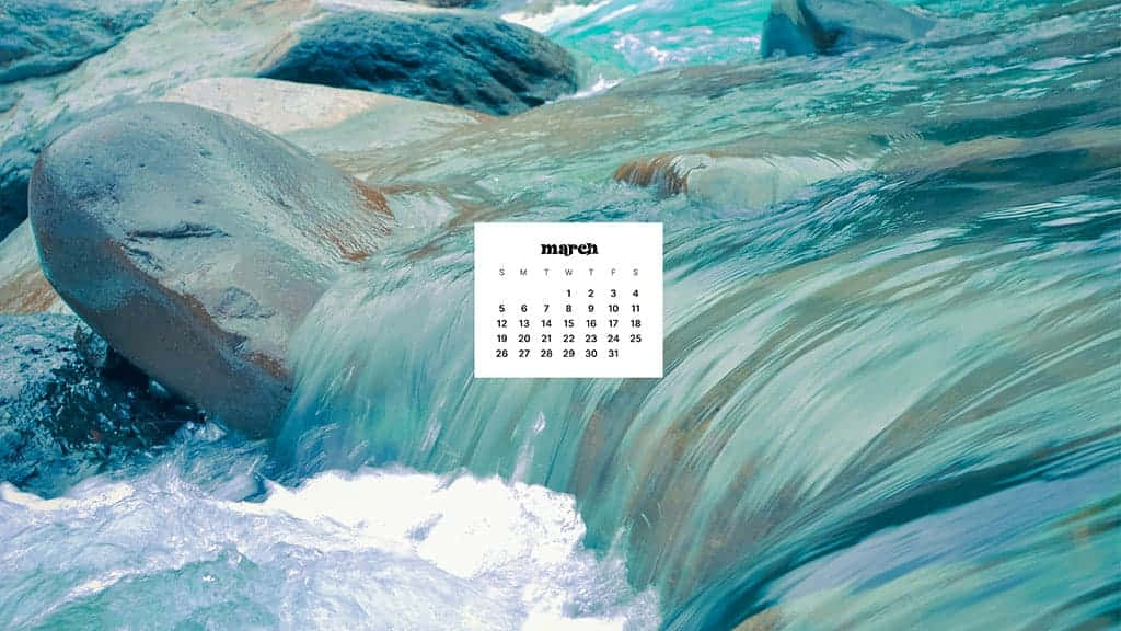 March Desktop 桌布 壁紙 — 三月日曆漂浮在奔騰的藍綠色水流之上，水流越過光滑的灰色河石傾瀉而下。