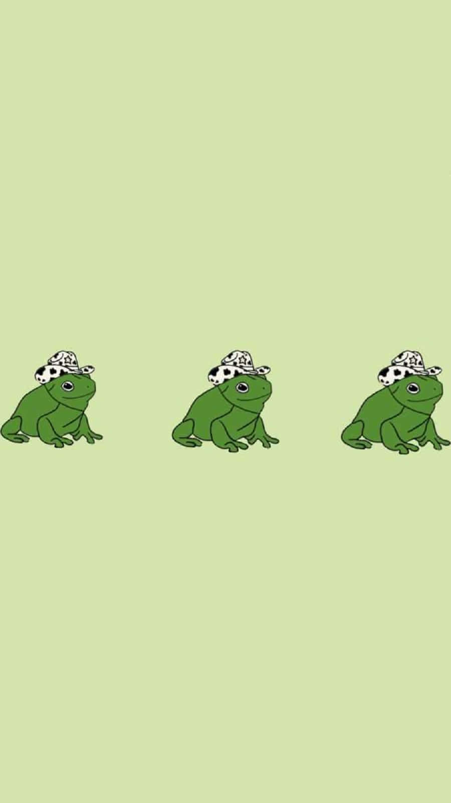 Cute Frog 桌布 壁紙 — 三隻卡通青蛙戴著大麥町印花帽子，排成一排坐在淺綠色背景前。