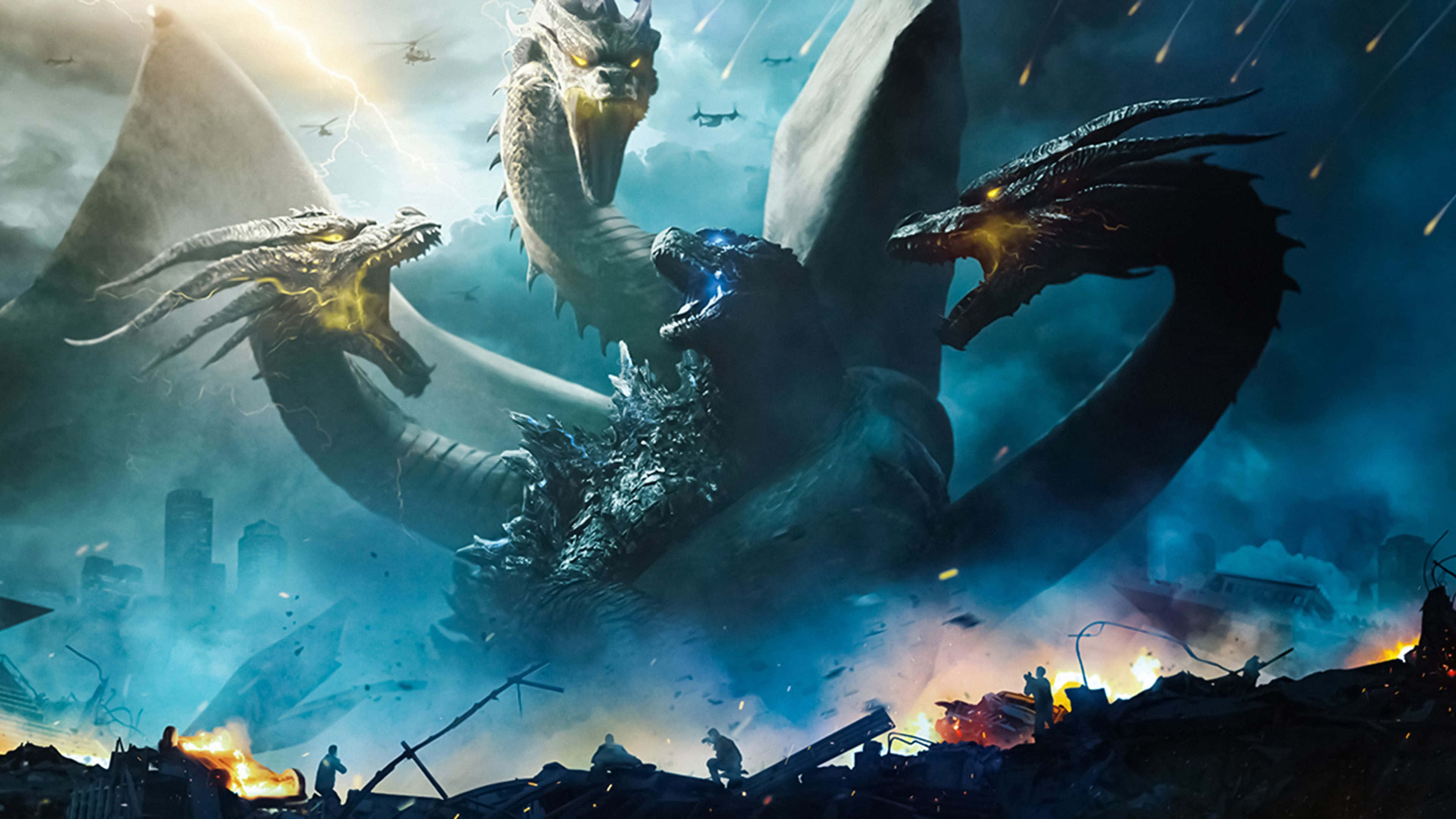Monsterverse 桌布 壁紙 — 三頭龍哥斯拉在燃燒的城市景觀上咆哮，直升機在暴風雨的天空和墜落的碎片中飛行。