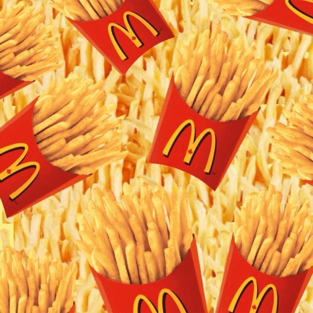 世界聞名的薯條 壁紙 — 金色薯條從標誌性的紅色麥當勞盒子中溢出，形成重複圖案。