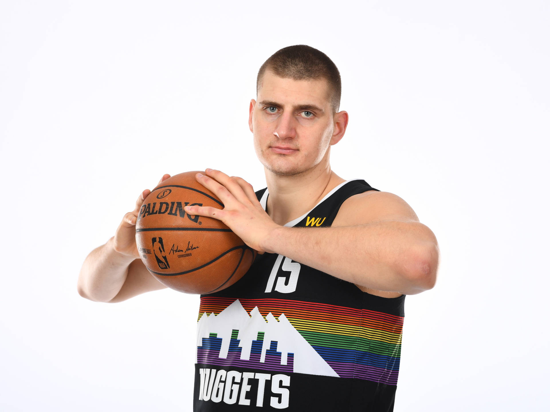 職業籃球運動員身穿丹佛金塊隊球衣，手持 Spalding 籃球。