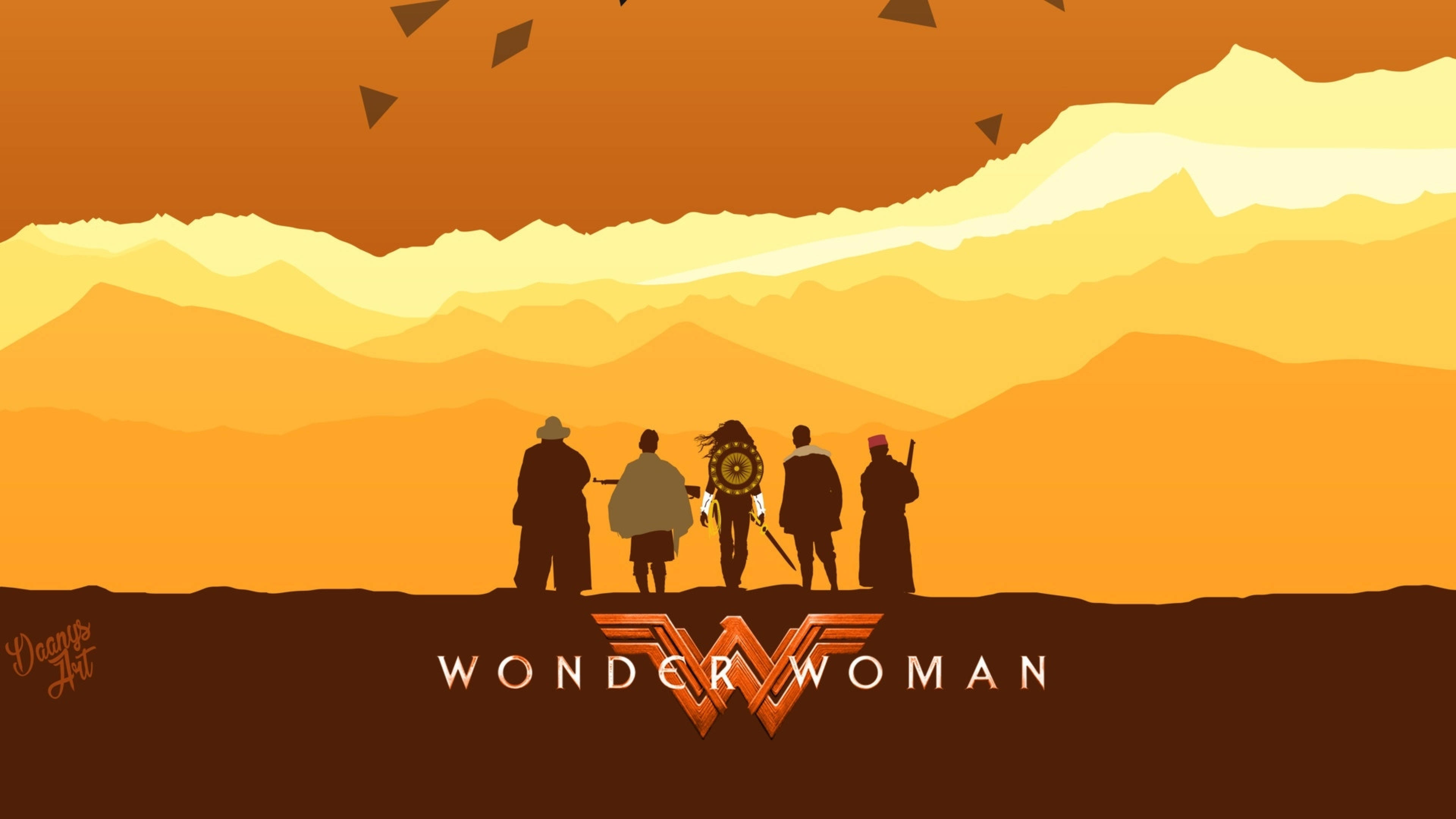 Be Brave like Wonder Woman 壁紙 — 五個剪影人物站在山頂上，觀看層層山脈上充滿活力的橙色和黃色日落。