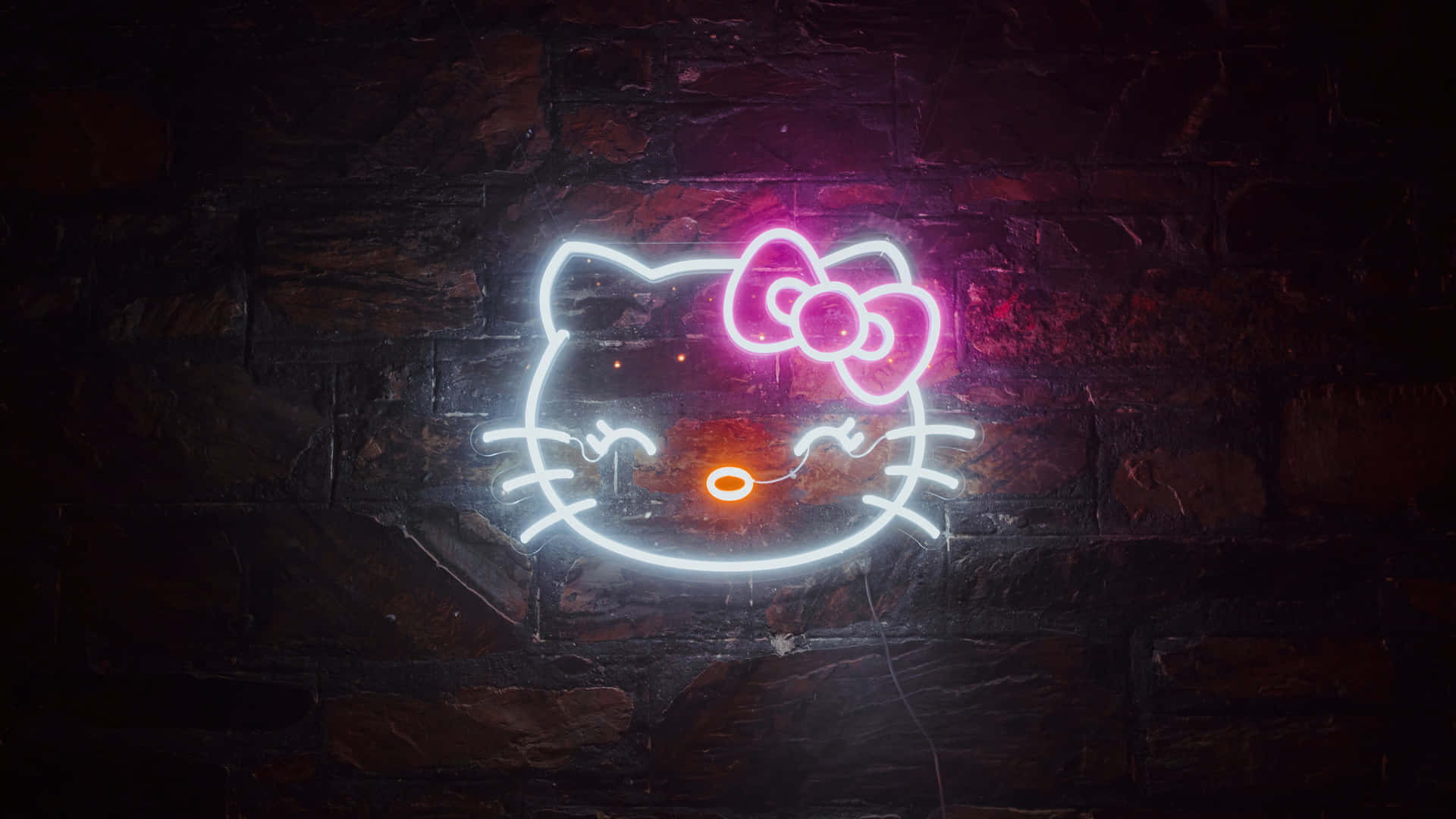 在深色磚牆上發光的Hello Kitty霓虹燈牌。