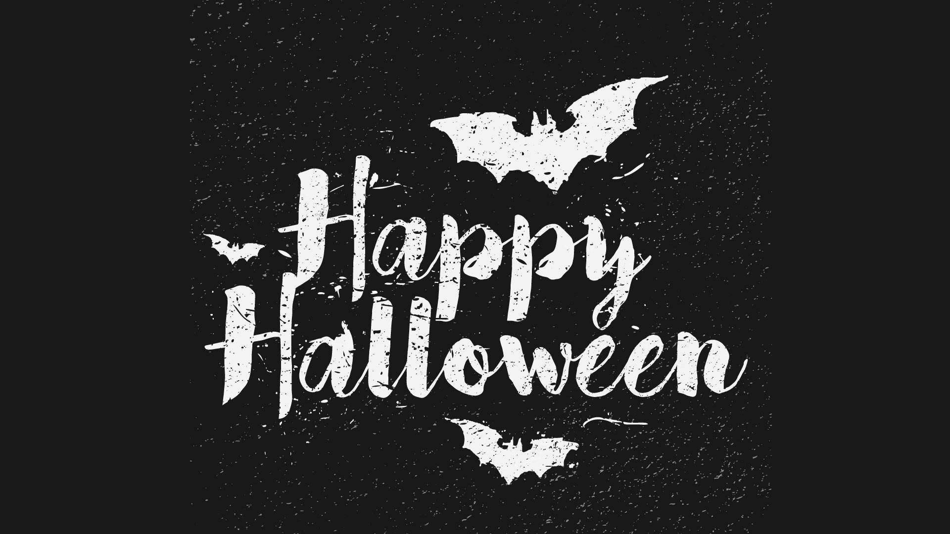 Happy Halloween 文字帶有蝙蝠，背景為斑點黑色。