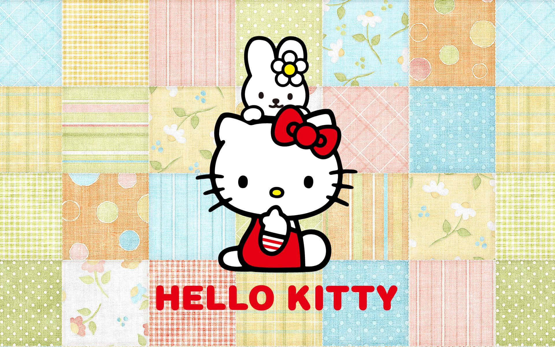 Hello Kitty 和兔子在拼布被子背景上，帶有紅色蝴蝶結和文字。