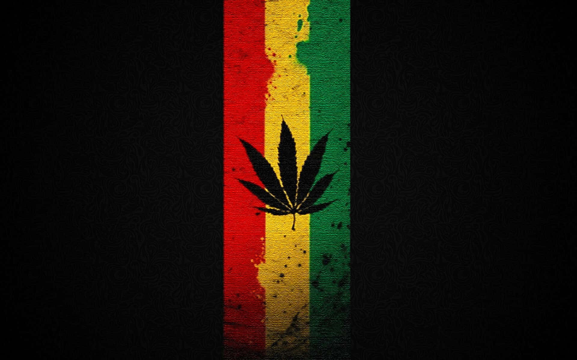 黑色大麻葉在紅黃綠條紋上，背景深色紋理。