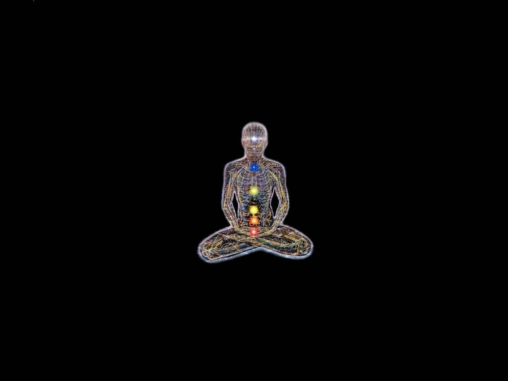 線框人體在黑色背景上冥想，帶有發光脈輪