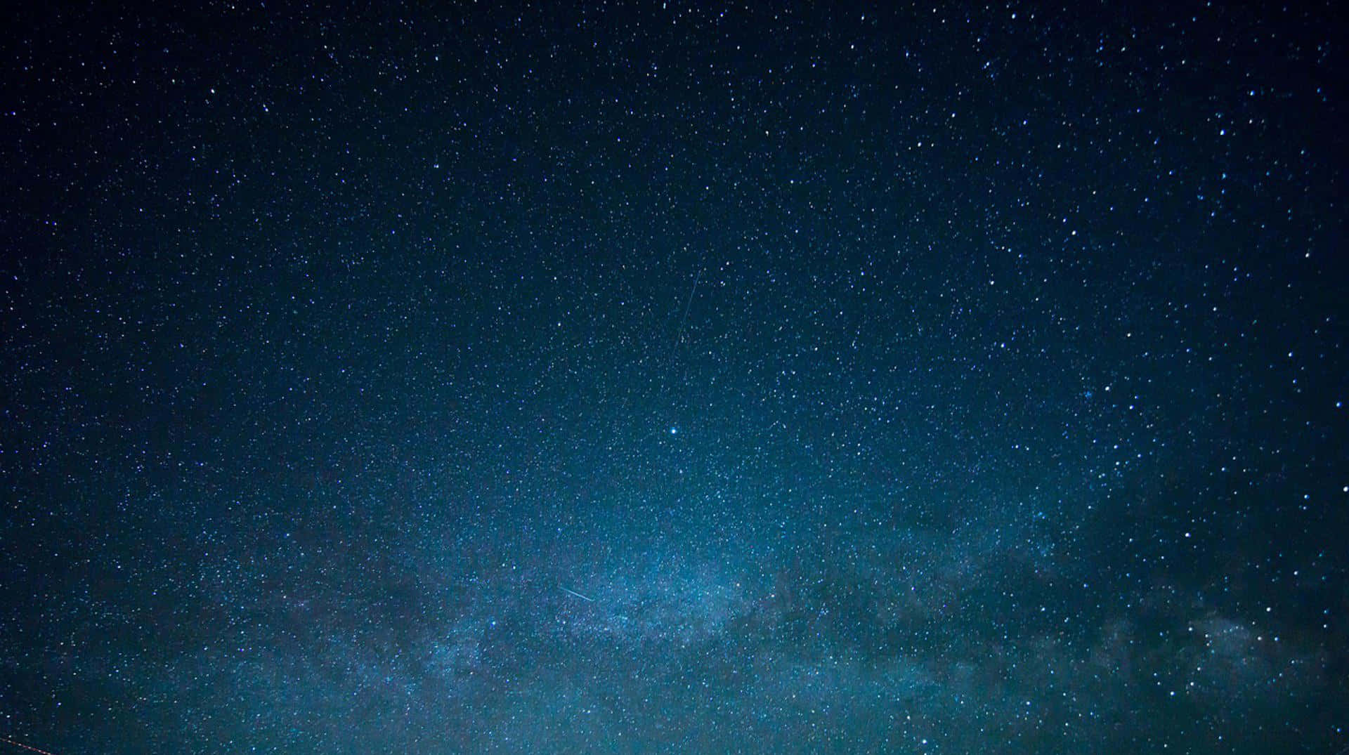 Starry Sky 桌布 壁紙 — 令人嘆為觀止的銀河系景觀，在深邃的藍色夜空中閃耀，佈滿無數星辰。