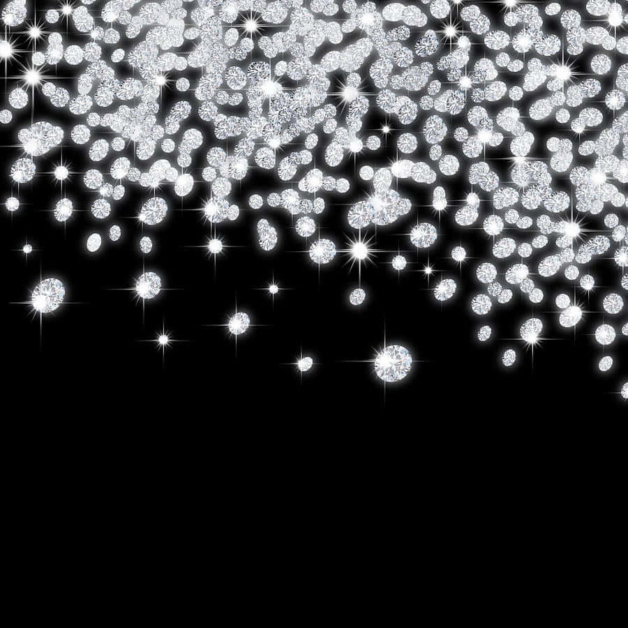 閃爍的鑽石和星爆從上方落在黑色背景上。