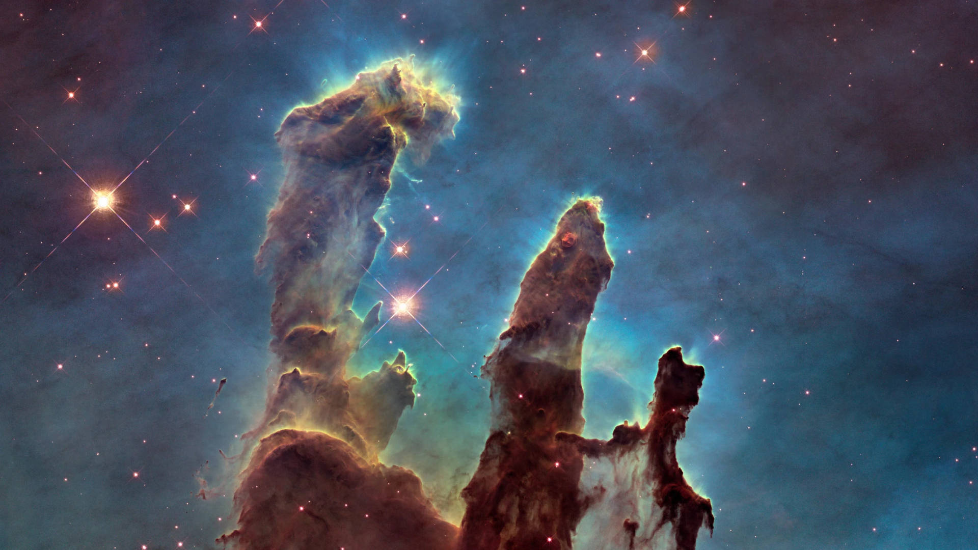 宇宙中發光的氣體和塵埃柱，伴隨著明亮的星星