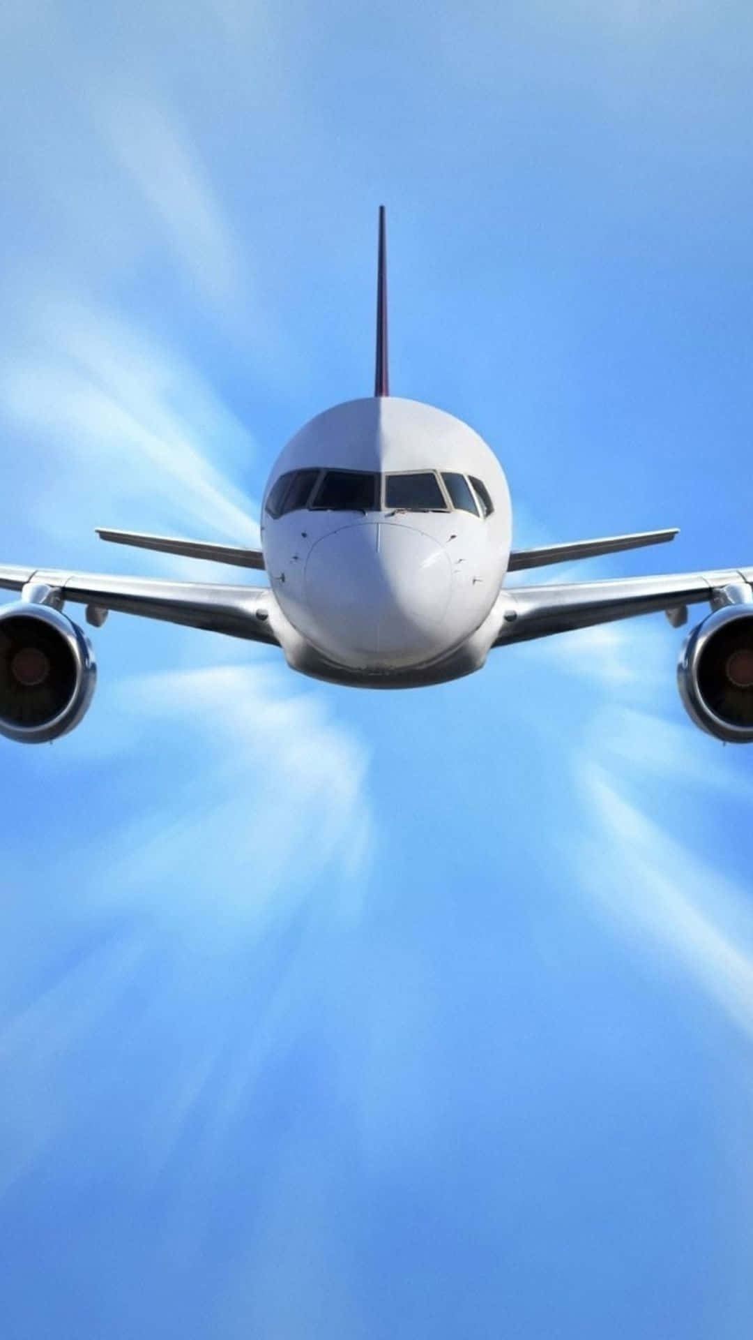 以 Android 設備欣賞小型飛機飛越藍天 壁紙 — 一架白色客機在藍天白雲中直接向觀眾飛來。
