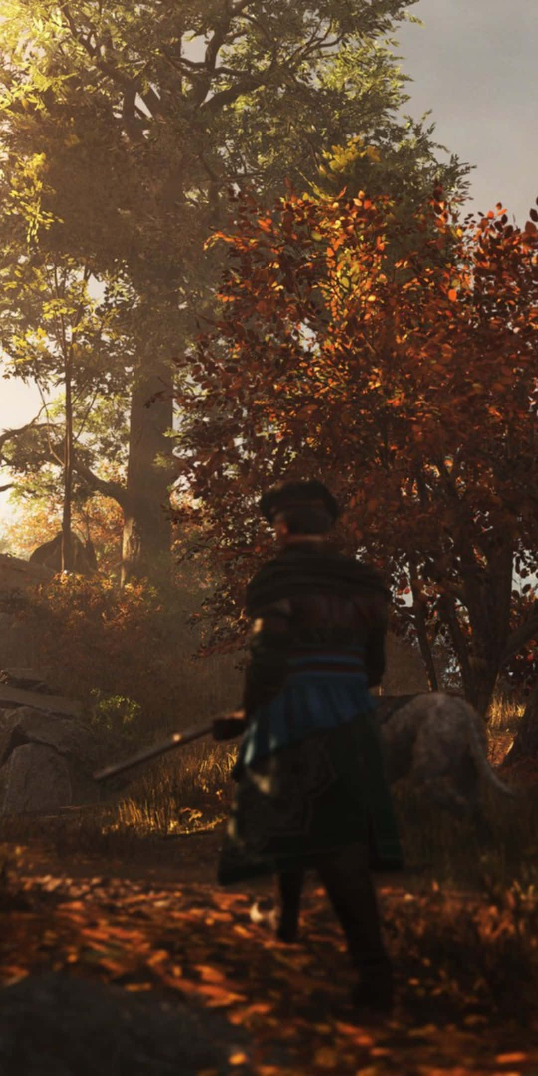 以 Google Pixel 3 探索 Greedfall 的奇幻世界 壁紙 — 一位身穿傳統服飾的戰士走過陽光明媚的秋日森林，金色樹葉在腳邊旋轉。