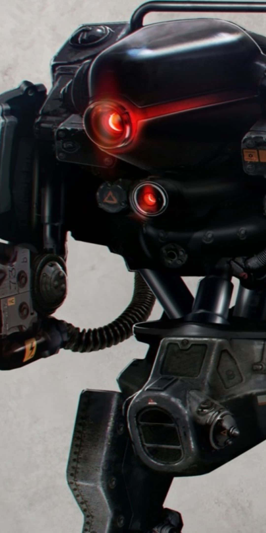 以 Pixel 3 和 Wolfenstein II 激發內在狼性 壁紙 — 近距離拍攝一個帶有發光紅眼和機械細節的威脅性黑色裝甲機械人，背景為灰色。