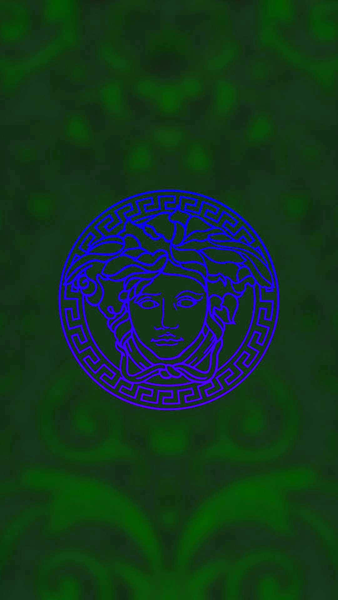 以 Versace iPhone 體驗奢華 壁紙 — 一個發光的藍色美杜莎頭標誌，位於深綠色紋理壁紙中央，帶有重複的華麗圖案。
