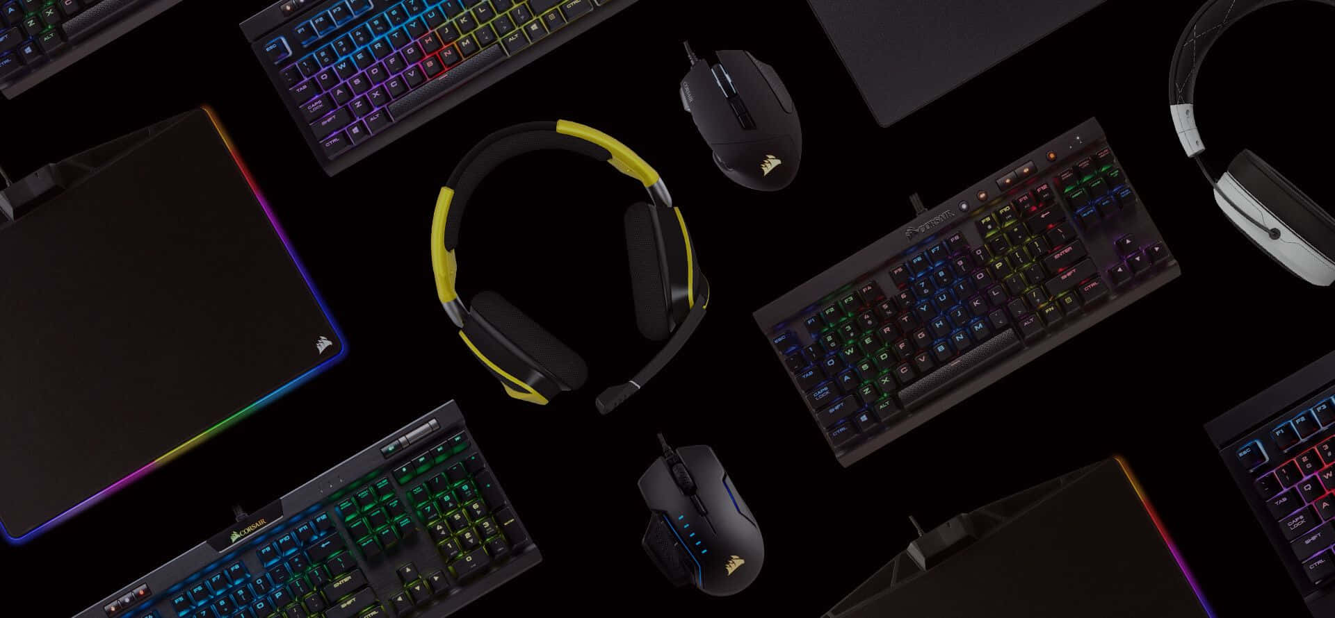 Gaming peripherals including keyboards mice and headphones with colorful backlighting.