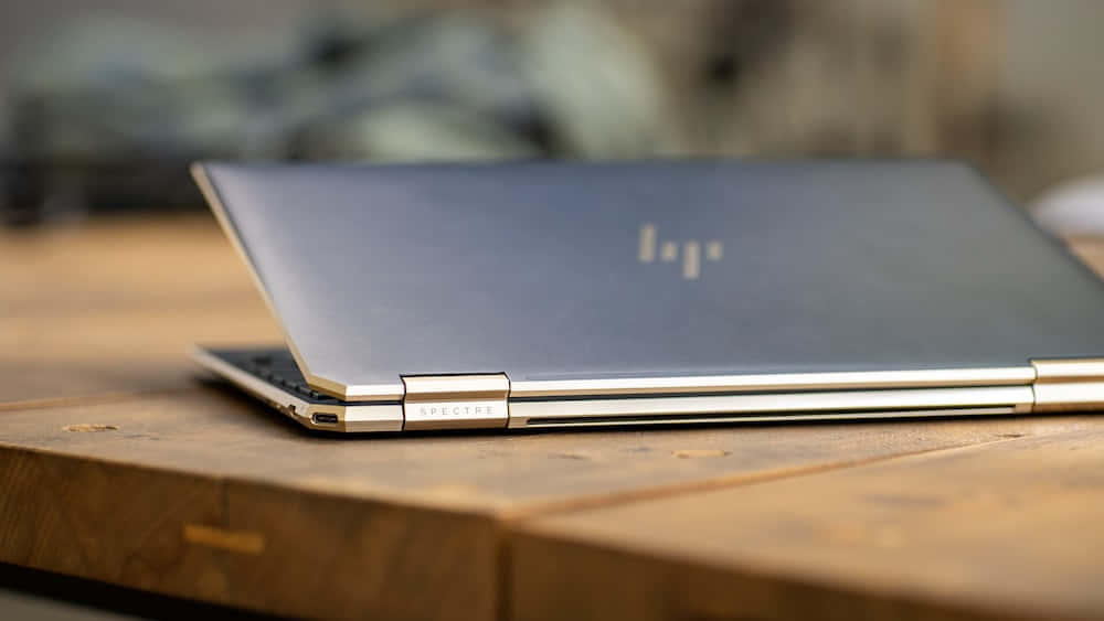 木質表面上的銀色 HP Spectre 筆記型電腦