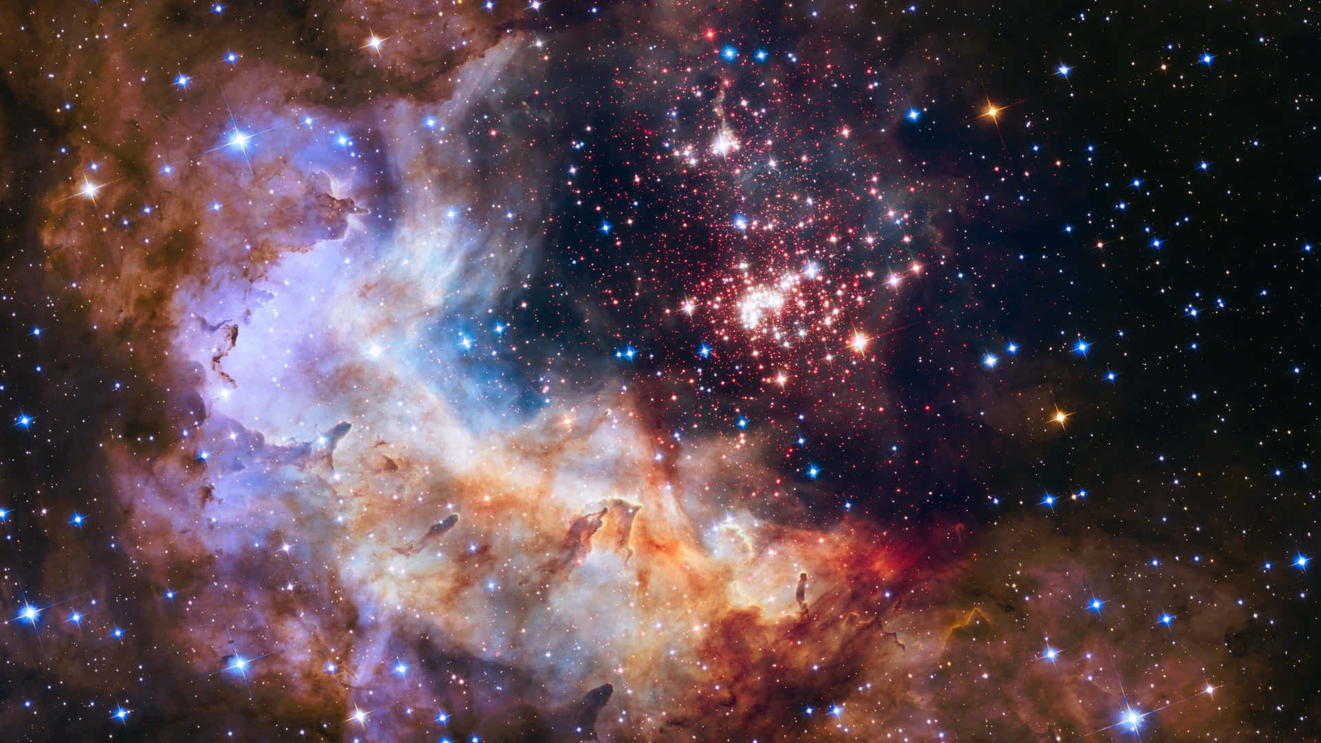 鮮豔的宇宙星雲在無數星星中散發出紅色、紫色和藍色的光芒。