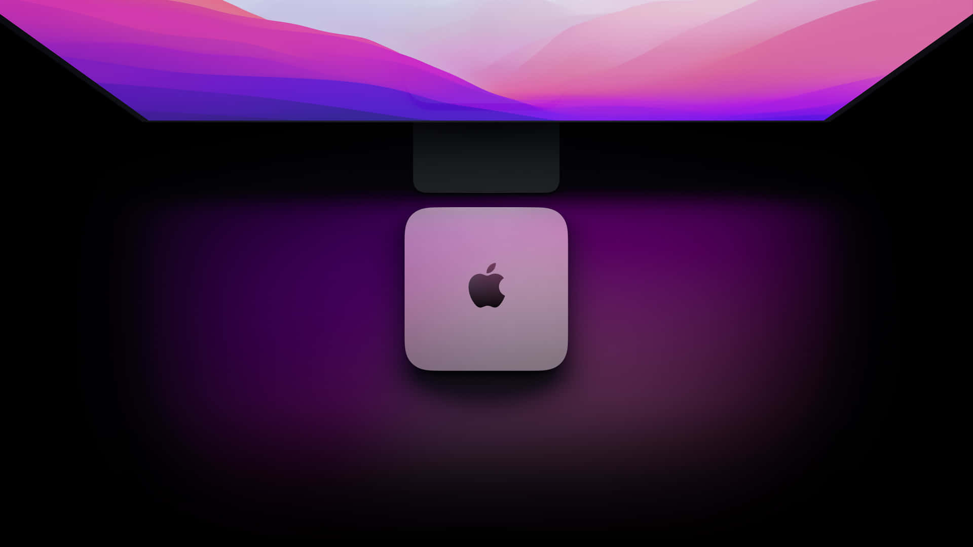 彩色漸變屏幕下的銀色 Apple Mac mini 電腦。
