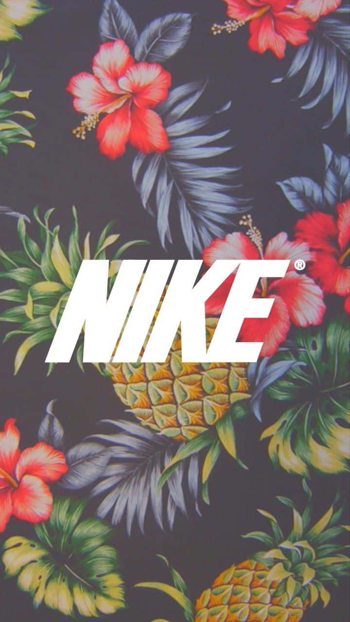 以全新Swag iPhone展現最新潮流 壁紙 — 大膽的白色Nike標誌置中於熱帶圖案上，圖案包括紅色芙蓉花、菠蘿和茂盛的綠葉，背景為深色。