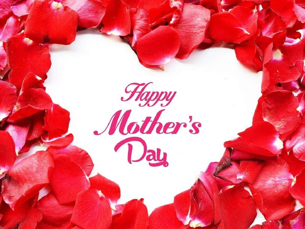 紅色玫瑰花瓣在「Happy Mother's Day」文字周圍形成一個心形。